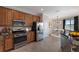 Eat-in kitchen, stainless steel appliances, and light wood cabinets at 13627 American Prairie Pl, Lakewood Ranch, FL 34211