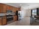 Eat-in kitchen, stainless steel appliances, and light wood cabinets at 13627 American Prairie Pl, Lakewood Ranch, FL 34211