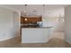 Modern kitchen with wood cabinetry and a breakfast bar at 13627 American Prairie Pl, Lakewood Ranch, FL 34211