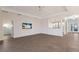 Open living room with a large TV and access to other rooms at 13627 American Prairie Pl, Lakewood Ranch, FL 34211