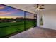 Screened patio overlooking a pond with sunset view at 13627 American Prairie Pl, Lakewood Ranch, FL 34211