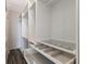 Large walk-in closet featuring built-in shelves and drawers at 13627 American Prairie Pl, Lakewood Ranch, FL 34211