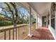 Brick back porch with columns and view of large tree at 1616 North Dr, Sarasota, FL 34239