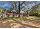 Large backyard with mature oak trees and a deck at 1616 North Dr, Sarasota, FL 34239
