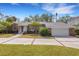 Brick ranch home with a two-car garage and well manicured lawn at 1616 North Dr, Sarasota, FL 34239