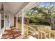 Brick front porch with columns overlooking a shady yard at 1616 North Dr, Sarasota, FL 34239