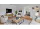 Living Room with hardwood floors, comfy seating, and a view into the dining area at 1616 North Dr, Sarasota, FL 34239