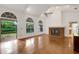Living room with hardwood floors, vaulted ceiling, fireplace and access to backyard at 1616 North Dr, Sarasota, FL 34239