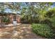 Landscaped side yard with mature trees and shrubs at 1616 North Dr, Sarasota, FL 34239