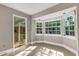 Sunroom with bay window, floral wallpaper, and access to outdoor patio at 1616 North Dr, Sarasota, FL 34239