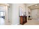 Foyer with tile flooring, wooden console table and view to living room at 16926 Harvest Moon Way, Bradenton, FL 34211