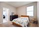 Bedroom with a bed and dresser, access to bathroom and hallway at 16926 Harvest Moon Way, Bradenton, FL 34211