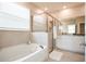 Modern bathroom with a soaking tub and walk-in shower at 16926 Harvest Moon Way, Bradenton, FL 34211