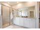 Elegant bathroom with double vanity and a walk-in shower at 16926 Harvest Moon Way, Bradenton, FL 34211