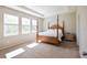 Spacious Primary bedroom with wood post bed frame and ample natural light at 16926 Harvest Moon Way, Bradenton, FL 34211
