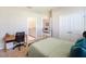 Bedroom with a bed, built-in desk, and en-suite bathroom at 16926 Harvest Moon Way, Bradenton, FL 34211
