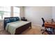 Bright bedroom with a double bed, workspace, and large windows at 16926 Harvest Moon Way, Bradenton, FL 34211