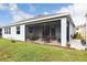 Home exterior with a screened patio and well-maintained lawn at 16926 Harvest Moon Way, Bradenton, FL 34211