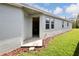 Home's exterior showcasing a side entrance and landscaping at 16926 Harvest Moon Way, Bradenton, FL 34211