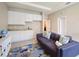 Cozy playroom with sofa, white cabinets, and rug at 16926 Harvest Moon Way, Bradenton, FL 34211