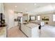 Open kitchen with large island, stainless steel appliances, and view into living room at 16926 Harvest Moon Way, Bradenton, FL 34211