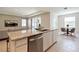 Open concept kitchen with island, stainless steel dishwasher, and adjacent dining area at 16926 Harvest Moon Way, Bradenton, FL 34211