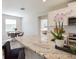 Kitchen features a granite countertop island, breakfast bar seating and views into the dining area at 16926 Harvest Moon Way, Bradenton, FL 34211