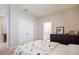 bedroom with a bed and dresser, and access to bathroom and hallway at 16926 Harvest Moon Way, Bradenton, FL 34211