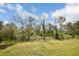 Vacant lot with mature trees and grassy area at 16926 Harvest Moon Way, Bradenton, FL 34211