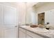 Double vanity bathroom with granite countertops and a large mirror at 16926 Harvest Moon Way, Bradenton, FL 34211