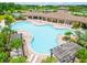 Large community pool with surrounding lounge chairs and shaded areas at 16926 Harvest Moon Way, Bradenton, FL 34211