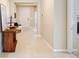 Light and bright foyer with tile floors and a wooden console table at 16926 Harvest Moon Way, Bradenton, FL 34211