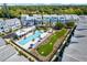 Aerial view of community pool, green space, and modern townhouses at 2400 Ezzell Ct, Sarasota, FL 34237