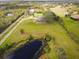 Aerial view of property showcasing a home and a pond at 31730 Clay Gully Rd, Myakka City, FL 34251
