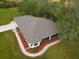 Aerial view of a house with a gray roof and landscaped yard at 31730 Clay Gully Rd, Myakka City, FL 34251