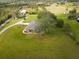 Aerial view showing a house on a spacious lot with surrounding greenery at 31730 Clay Gully Rd, Myakka City, FL 34251