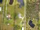 Aerial view showing a house, pool, and outbuildings on a large lot at 31730 Clay Gully Rd, Myakka City, FL 34251