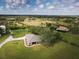 Aerial view of a home on a large lot with surrounding landscape at 31730 Clay Gully Rd, Myakka City, FL 34251