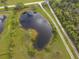 Aerial close-up showcasing a tranquil pond on the property at 31730 Clay Gully Rd, Myakka City, FL 34251