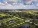 Aerial view of expansive property with lush pastures, ponds, and a large building at 31730 Clay Gully Rd, Myakka City, FL 34251