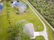 Aerial view of home and pond on a large lot at 31730 Clay Gully Rd, Myakka City, FL 34251