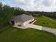 Aerial view of the house, garage, and surrounding land at 31730 Clay Gully Rd, Myakka City, FL 34251