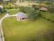 Aerial view of a single-story home on a large lot with pond at 31730 Clay Gully Rd, Myakka City, FL 34251