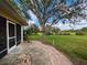 Brick patio and large backyard with mature trees at 31730 Clay Gully Rd, Myakka City, FL 34251