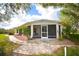 Enjoy the outdoors in the backyard featuring a screened patio, beautiful landscaping, and lush surroundings at 31730 Clay Gully Rd, Myakka City, FL 34251