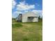 Large metal barn with a covered awning area at 31730 Clay Gully Rd, Myakka City, FL 34251