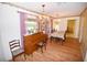 Formal dining room features hardwood floors, a piano and large windows at 31730 Clay Gully Rd, Myakka City, FL 34251
