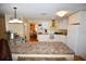 Spacious kitchen with white cabinets, granite countertops, and stainless steel appliances at 31730 Clay Gully Rd, Myakka City, FL 34251