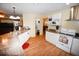 Open kitchen boasts white cabinets, granite countertops and hardwood floors at 31730 Clay Gully Rd, Myakka City, FL 34251