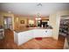 Island kitchen features white cabinets, granite countertops, and hardwood floors at 31730 Clay Gully Rd, Myakka City, FL 34251